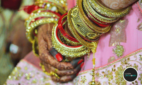 A woman wearing gold jewelries.