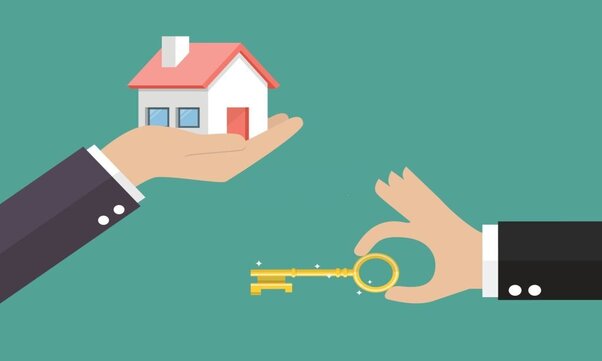 A hand holding a key for a house to be rented.